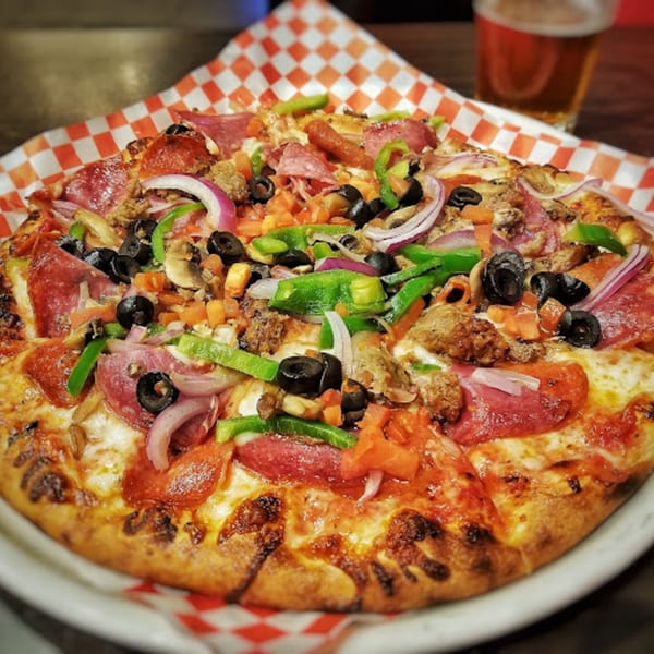 Cali-Forno Pizzeria's loaded pizza with pepperoni, sausage, olives, peppers, onions, and mushrooms.